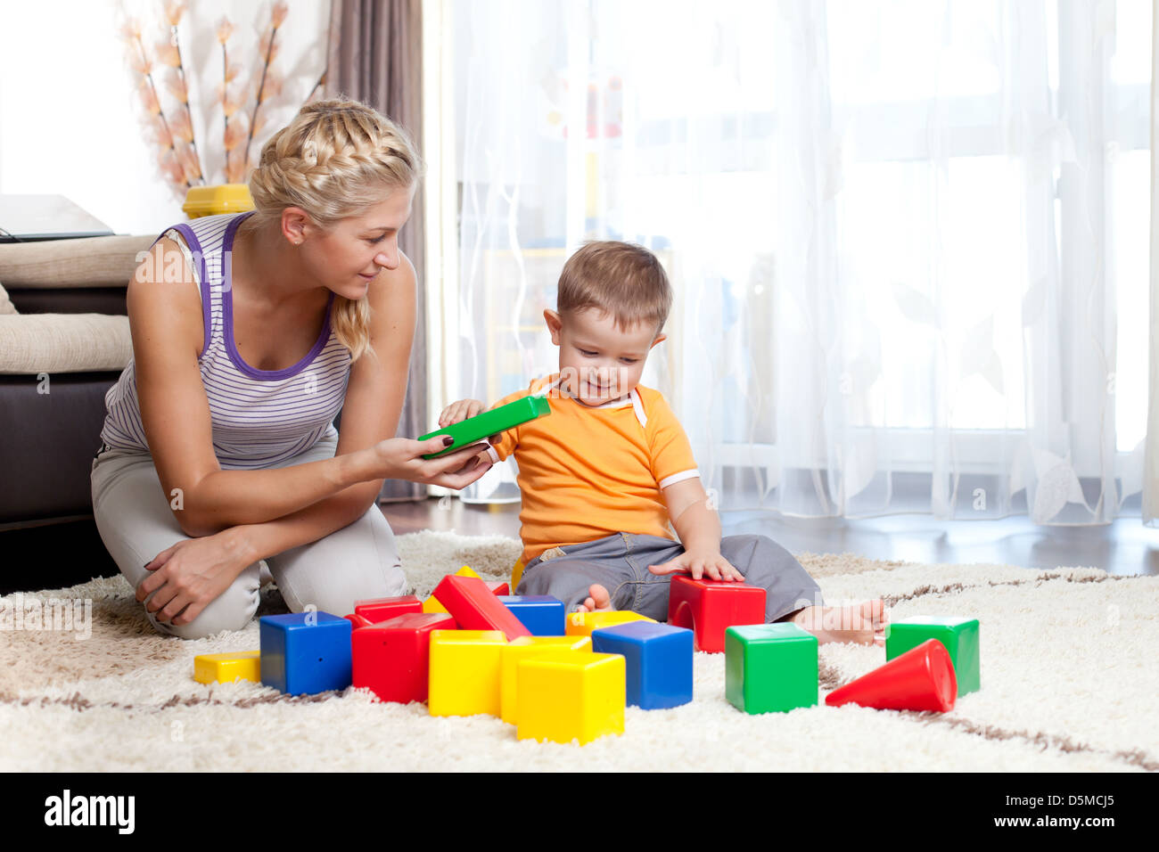 cute mother and kid boy playing together indoor Stock Photo