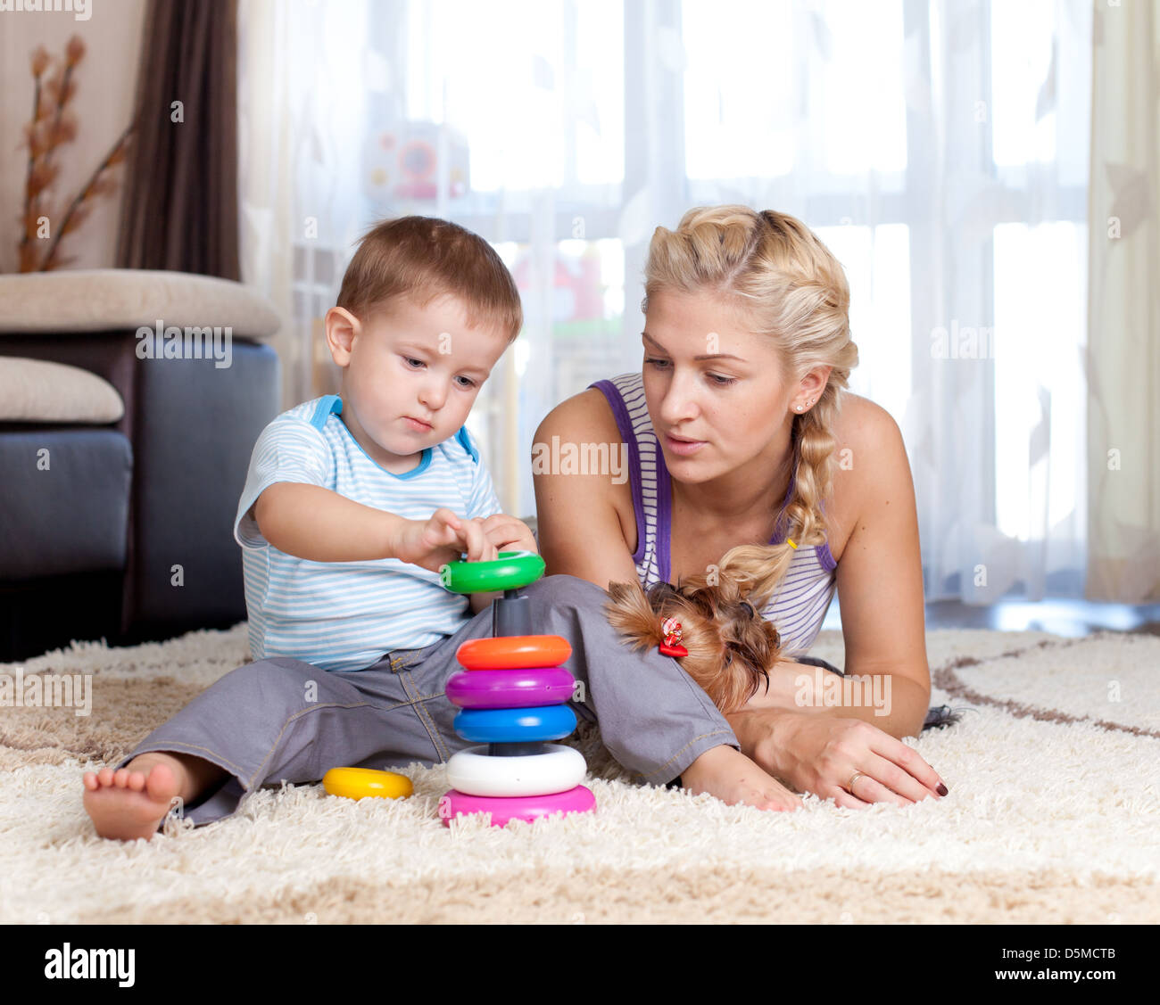 cute mother and kid boy playing together indoor Stock Photo