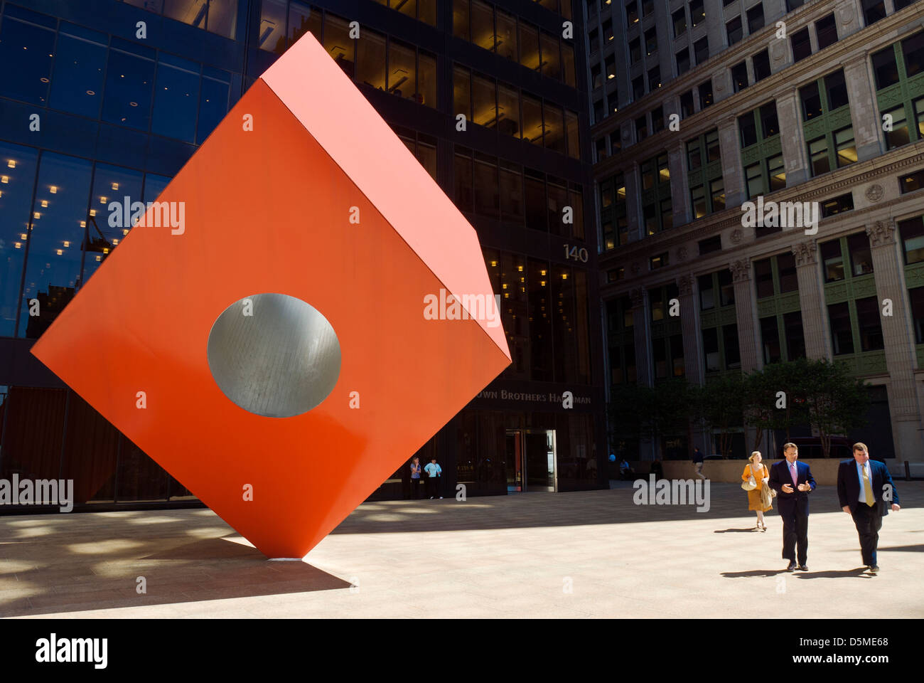 Red Cube (1968), by sculptor Isamu Noguchi, at 140 Broadway, financial district, New York City. Stock Photo