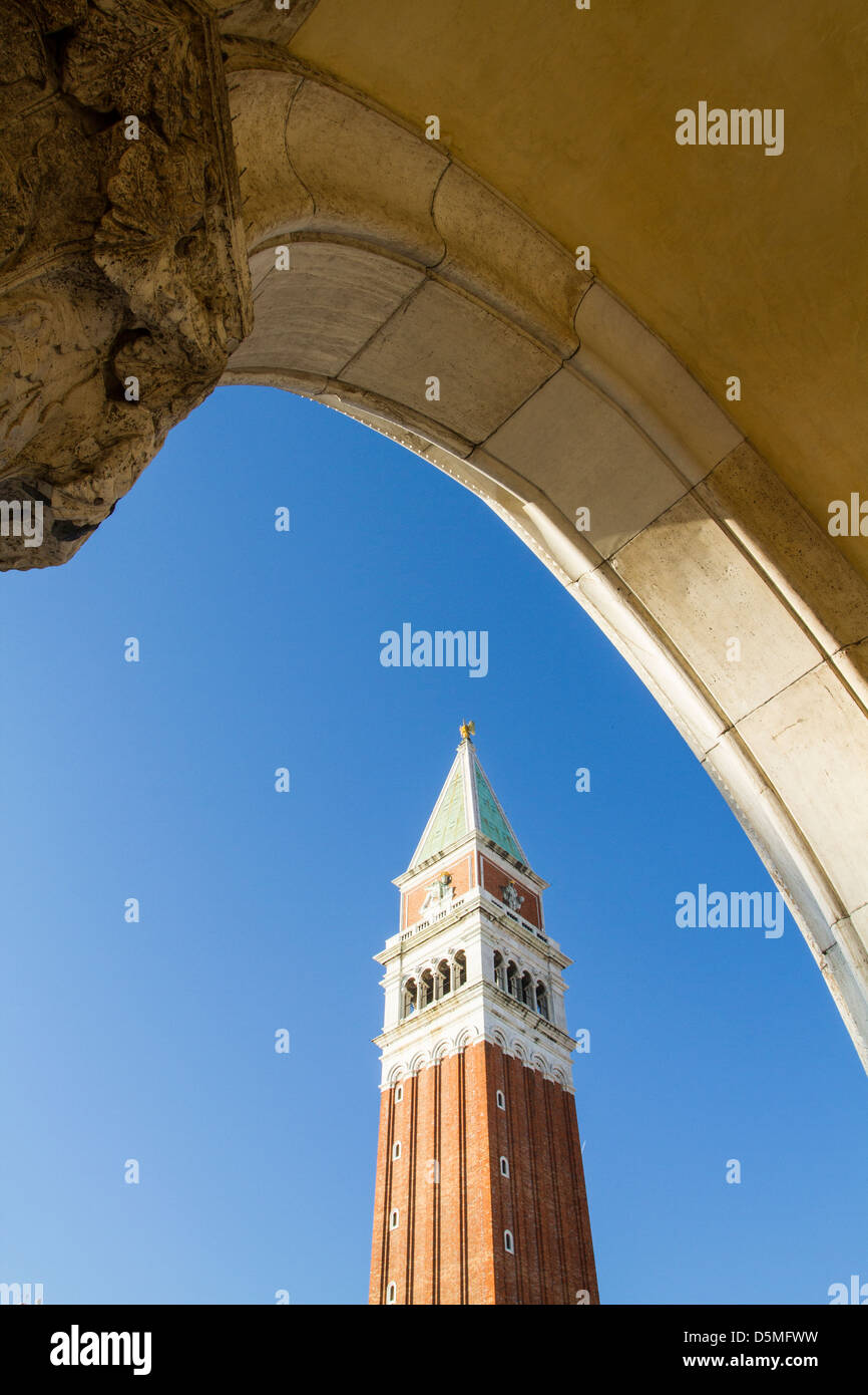 Saint Mark Campanile (Campanile di San Marco) viewed from the arches of Doge's Palace (Palazzo Ducale). Stock Photo