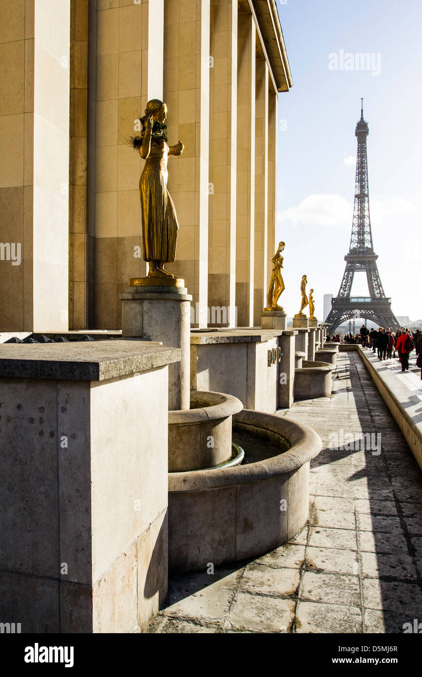 Gilded bronze statues at Palais de Chaillot and Eiffel Tower (Tour Eiffel) in the background. Stock Photo