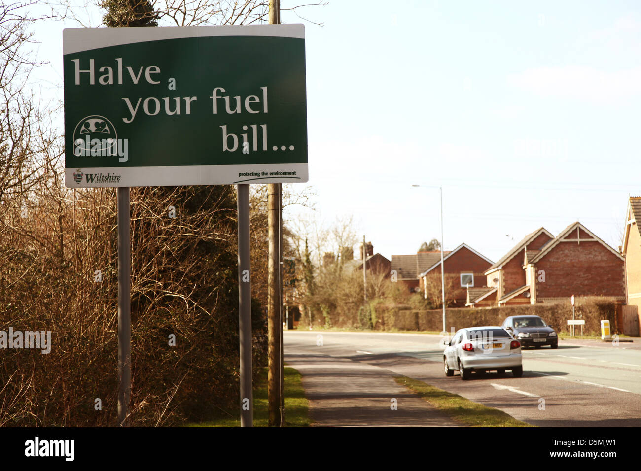 Halve your fuel bill, sign on a busy road to encourage folk to share their car journeys Chippenham, April 2013 Stock Photo