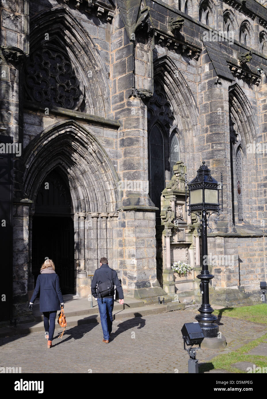 Man and woman entering Glasgow Cathedral in Scotland, UK Stock Photo