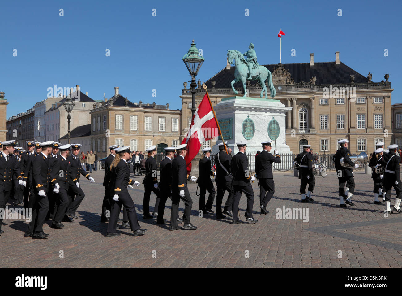 Copenhagen, Denmark. April 4th 2013. Cadets from the Royal Danish Naval Academy accompanied by the playing and singing Royal Danish Navy Band  passing the Amalienborg Palace Square during their “Flag on Board” parade through Copenhagen to mark the beginning of a new sailing season. Credit:  Niels Quist / Alamy Live News Stock Photo