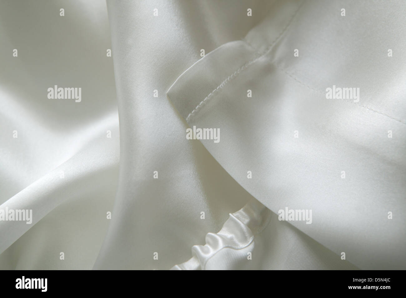 folds of luxury bedlinen silk sheets Stock Photo