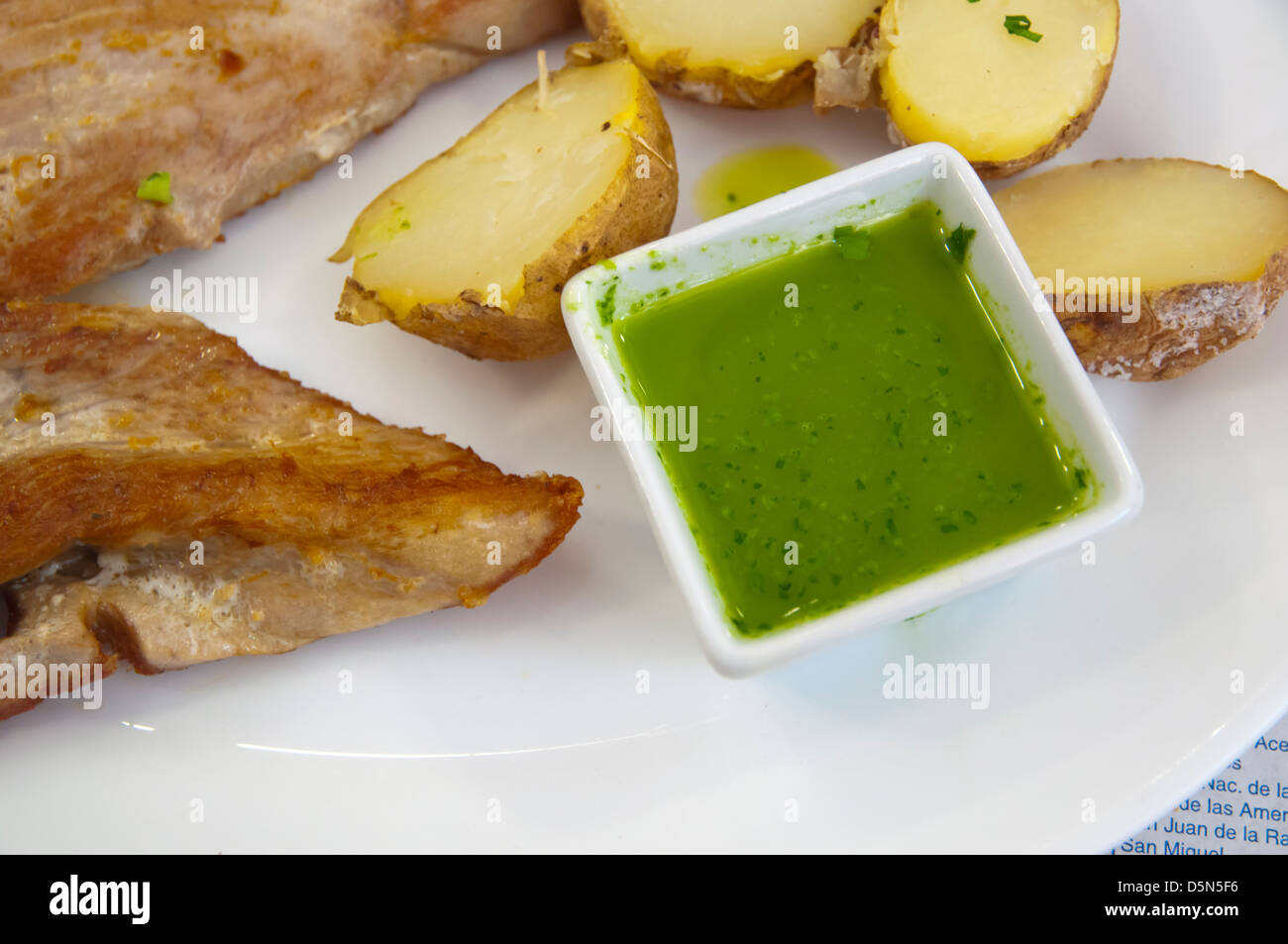 Grilled tuna fish and canarian potatoes with green mojo sauce Santa Cruz city Tenerife island the Canary Islands Spain Europe Stock Photo