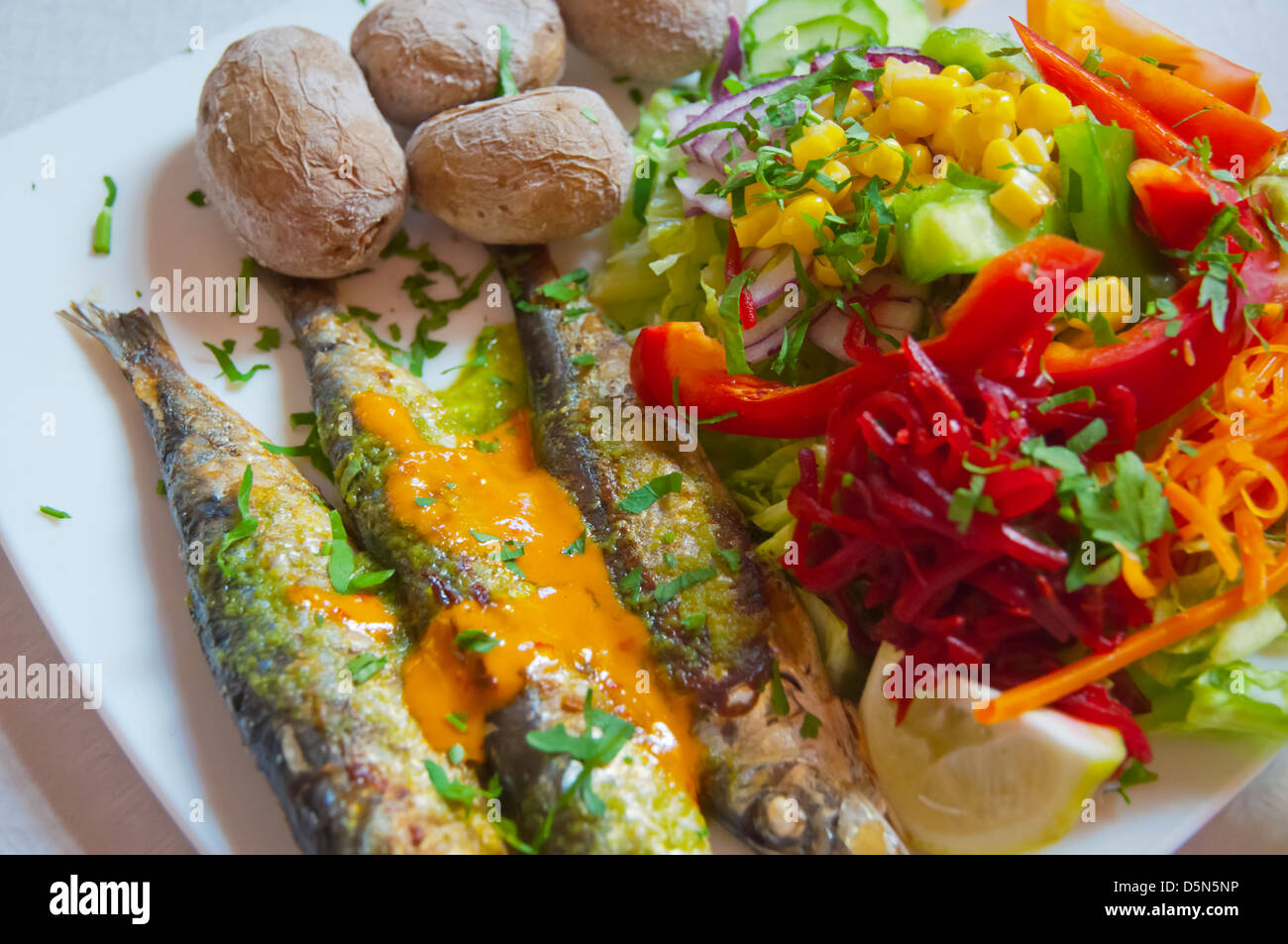 Grilled sardines potatoes and salad in a restaurant San Andres town