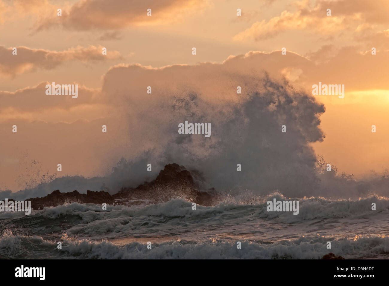 waves crashing on rocks at sunset, Fuerteventura Stock Photo