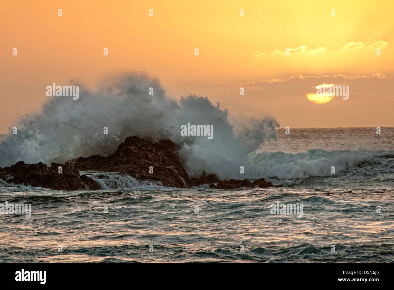 waves crashing on rocks at sunset, Fuerteventura Stock Photo