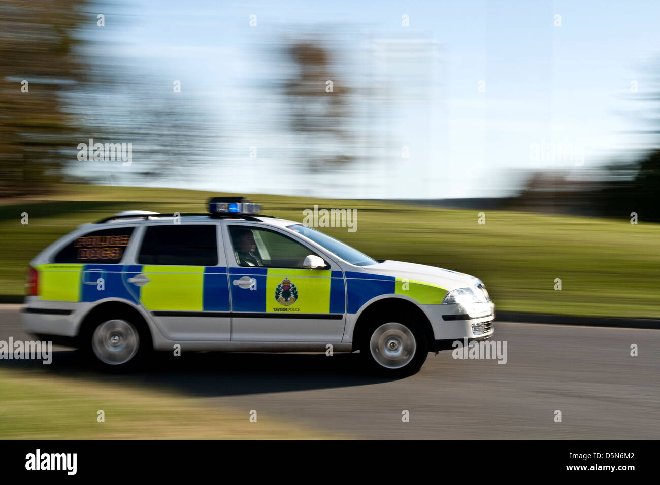 A Tayside Police car (now Police Scotland) speeds around a roundabout