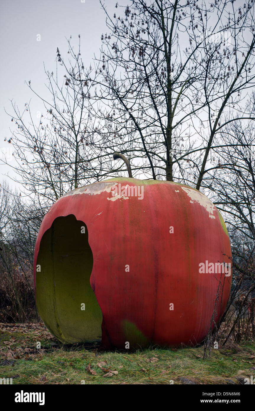 Italy. Big apple in abandoned fun fair. Big apple  train tunnel Stock Photo