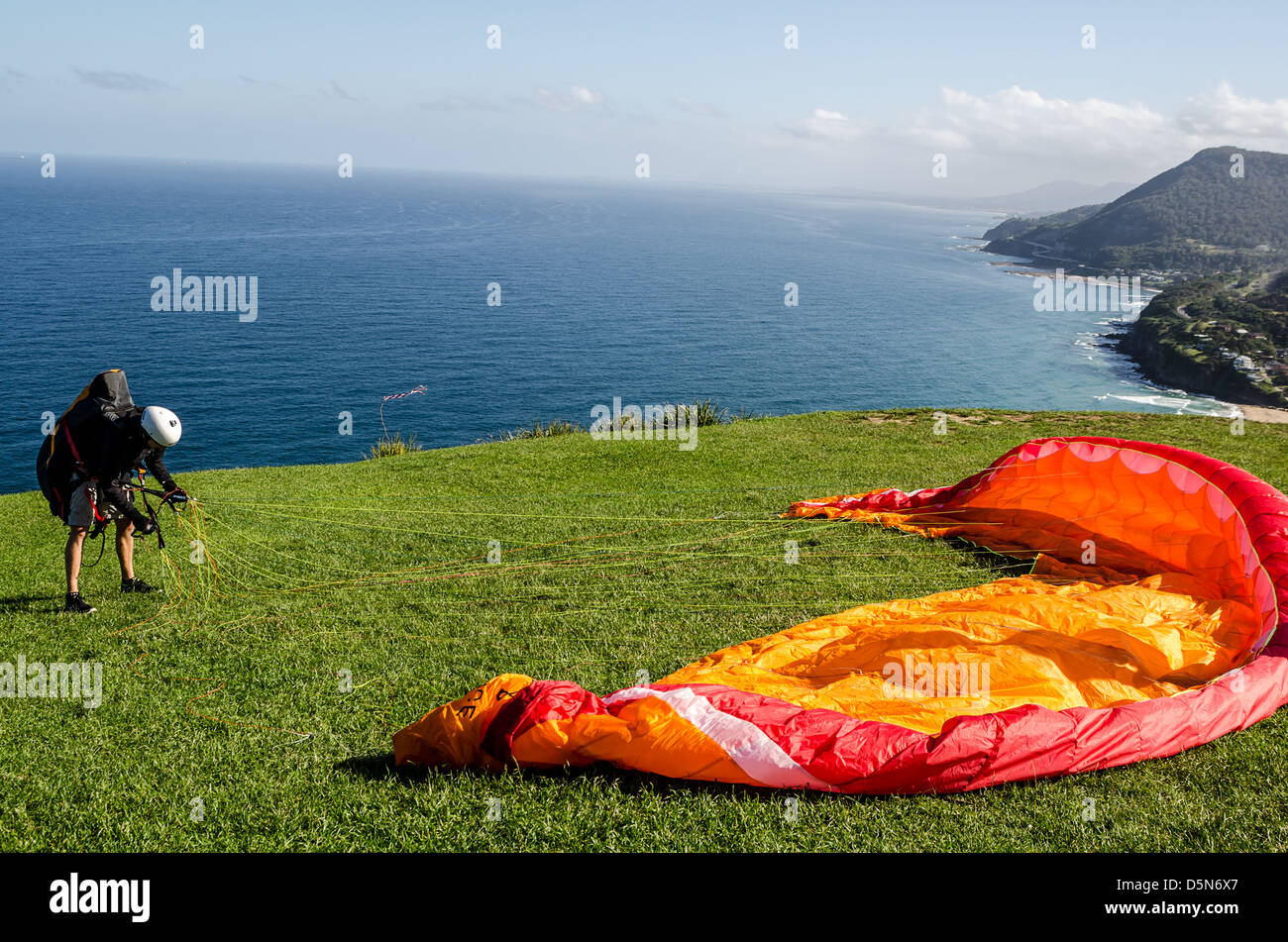 Hang gliding enthusiasts take the the skies creating a graceful spectacle at Stanwell Tops, Australia. Stock Photo