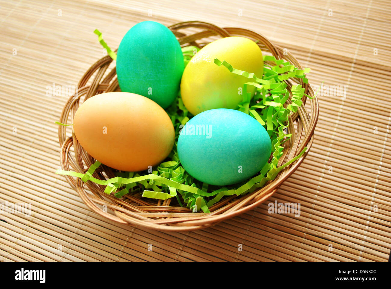 Colorful Easter Eggs in a Basket Stock Photo