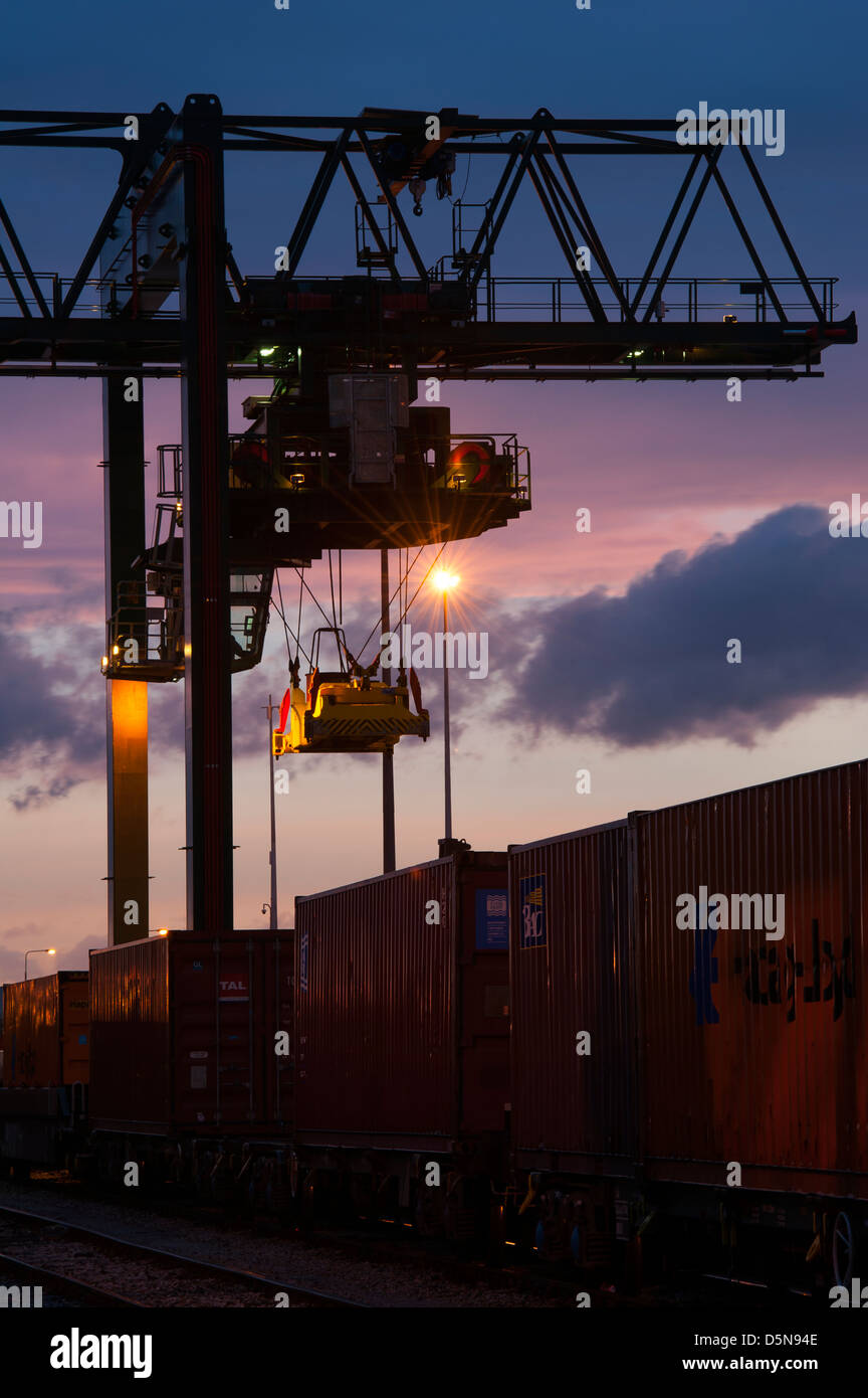 Beautiful view of cranes working at Manchester Freightliner railway freight terminal at dusk. Stock Photo
