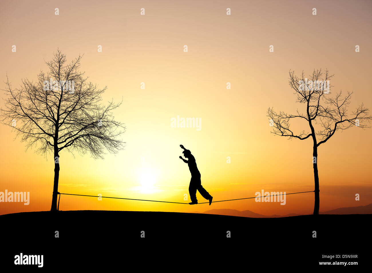 Person slacklining in nature with a sunset backdrop