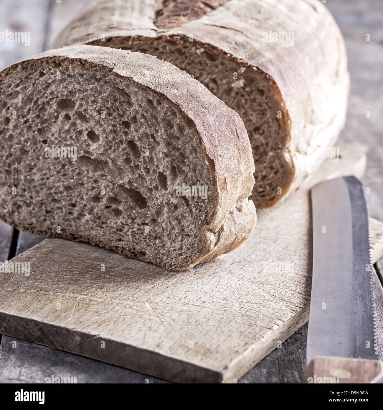 homemade bread and bread knife on table Stock Photo