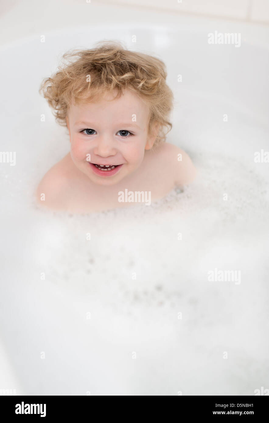 Young Boy, 2 years, having a bubble bath Stock Photo