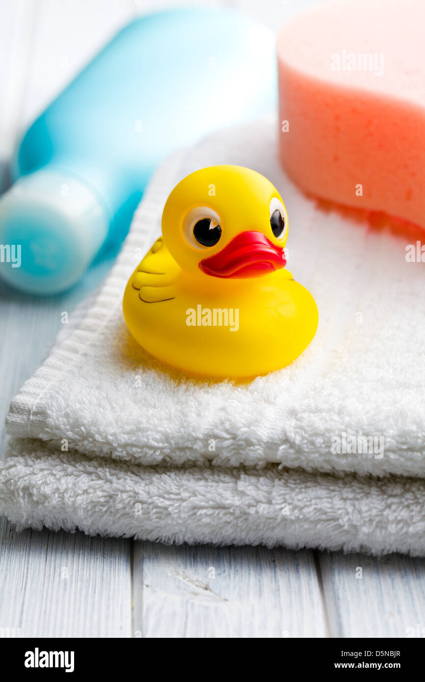 the yellow bath duck on white towel Stock Photo - Alamy