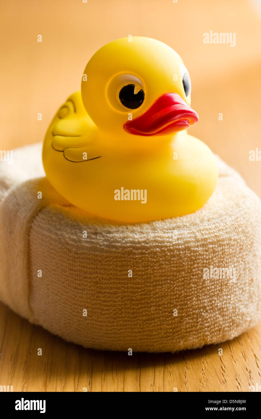 yellow bath duck on wooden table Stock Photo - Alamy