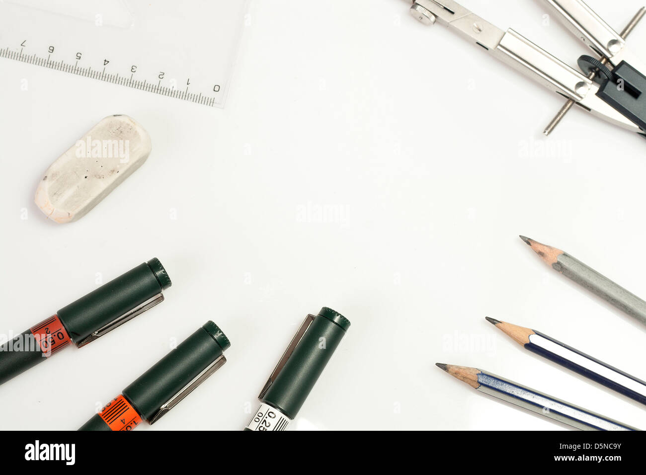 Background made of ruler, drawing compass, technical pens, pencils, rubber gum isolated on white background Stock Photo