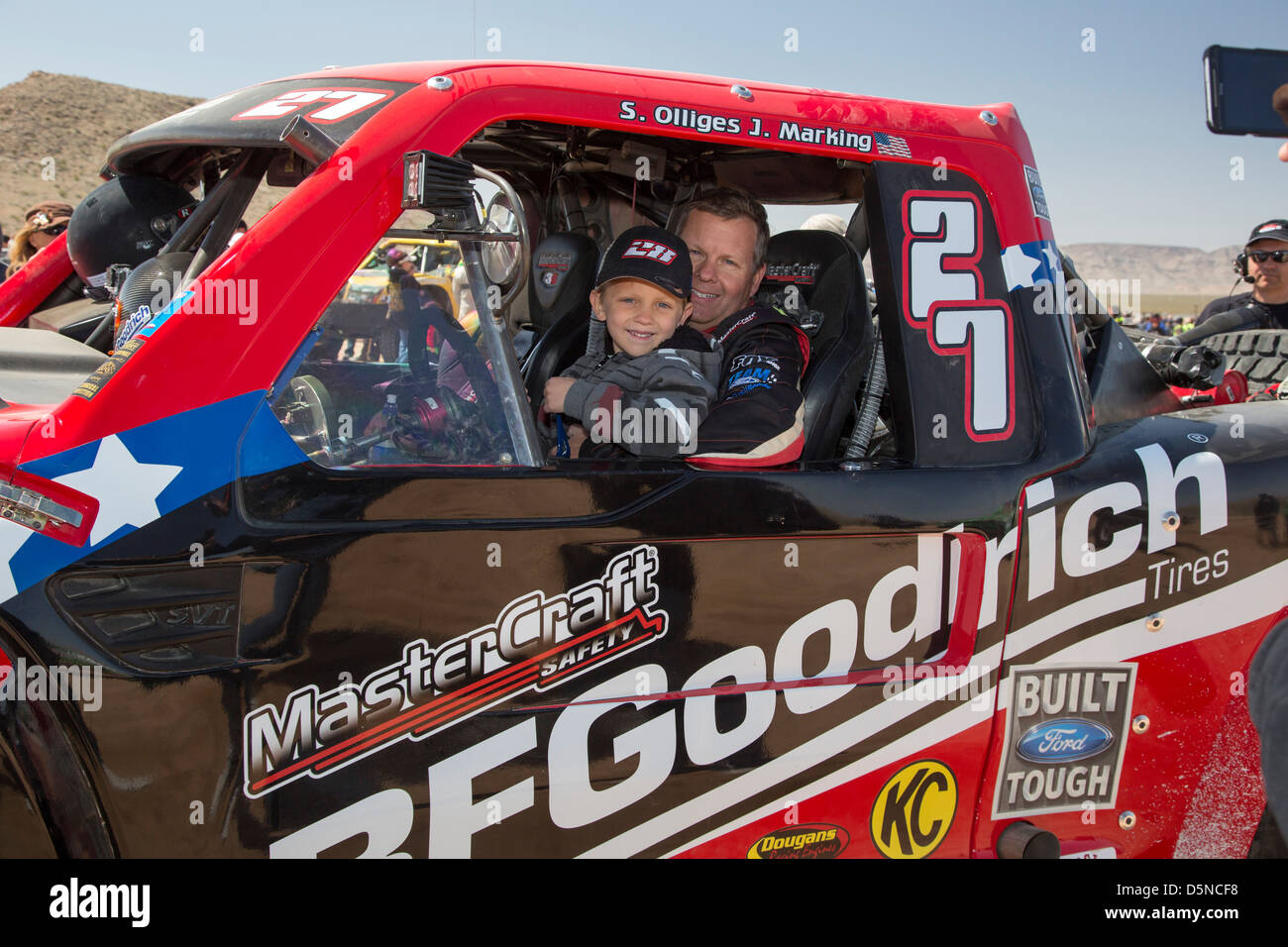 A driver and his son before the start of the Mint 400 off-road auto race through the Mojave Desert. Stock Photo