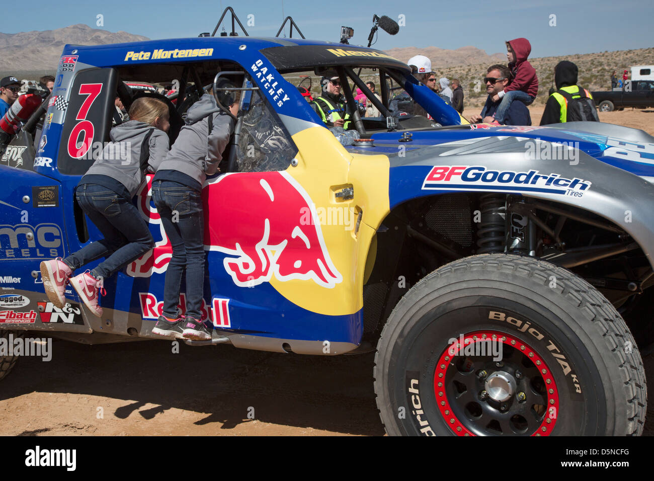 Two girls inspect the cab of a race car before the start of the Mint 400 off-road auto race through the Mojave Desert Stock Photo