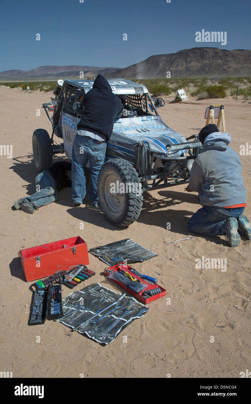 Crew members work on a car in the pits during the Mint 400 off-road auto race through the Mojave Desert Stock Photo
