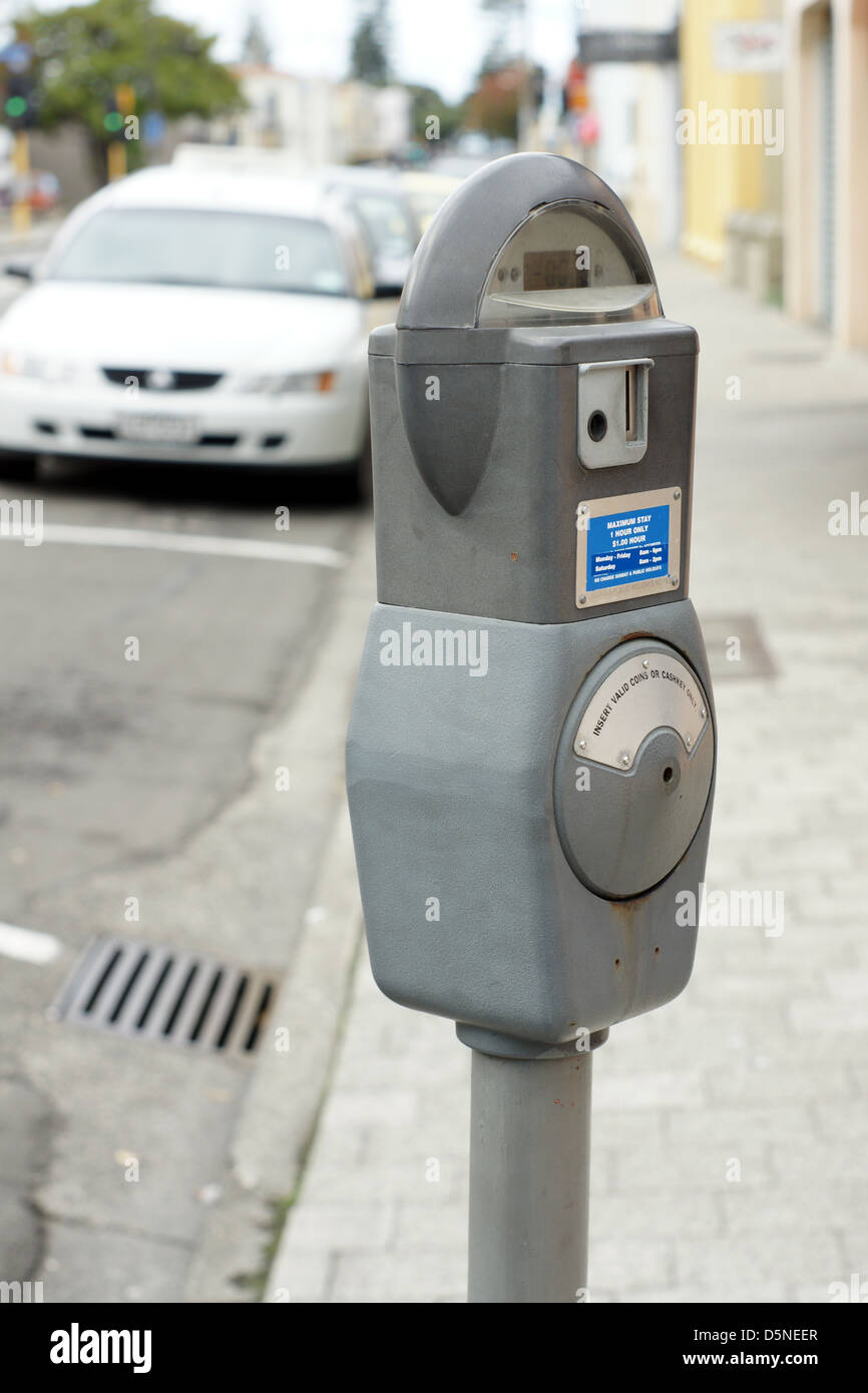 On street coin operated parking meter in an urban street Stock Photo