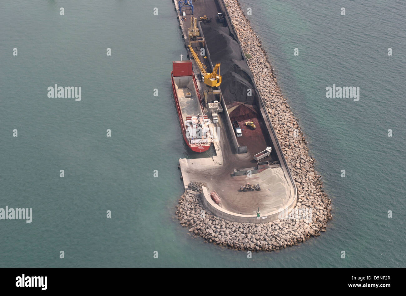 Aerial view of a coal container boat loading at Alcudia´s port dock, in the Spanish island of Mallorca Stock Photo