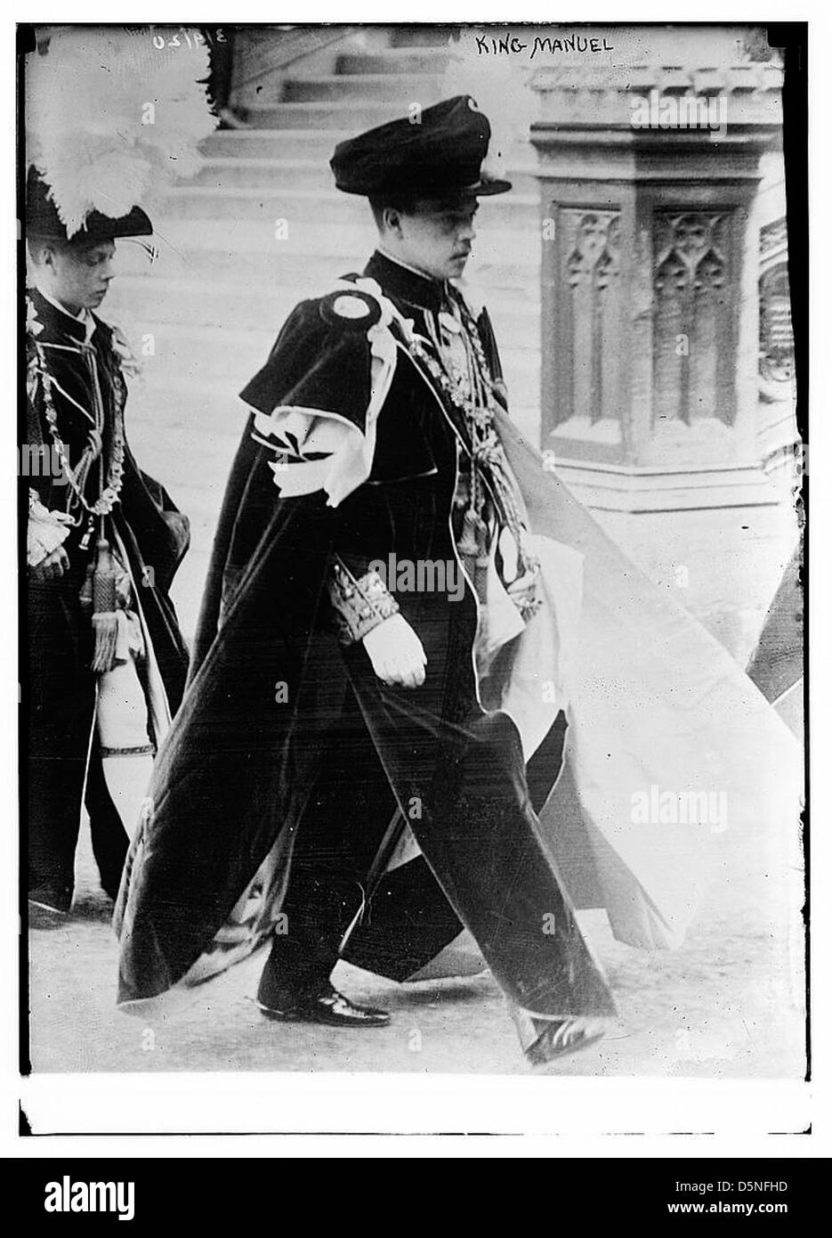 A detailed portrait of King Manuel II of Portugal, the last monarch of Portugal, dressed in ceremonial robes. King Manuel was also a member of European royalty and the Order of the Garter. This photograph captures his regal attire and formal bearing, symbolizing the monarchy’s last days in Portugal. Stock Photo