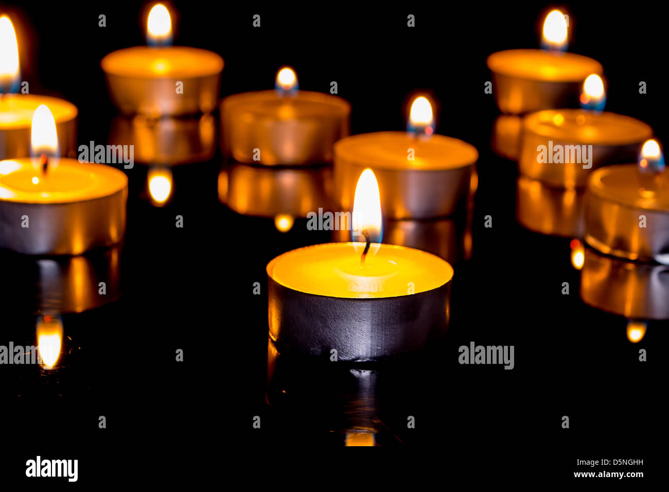 Group of burning candles on black background Stock Photo - Alamy