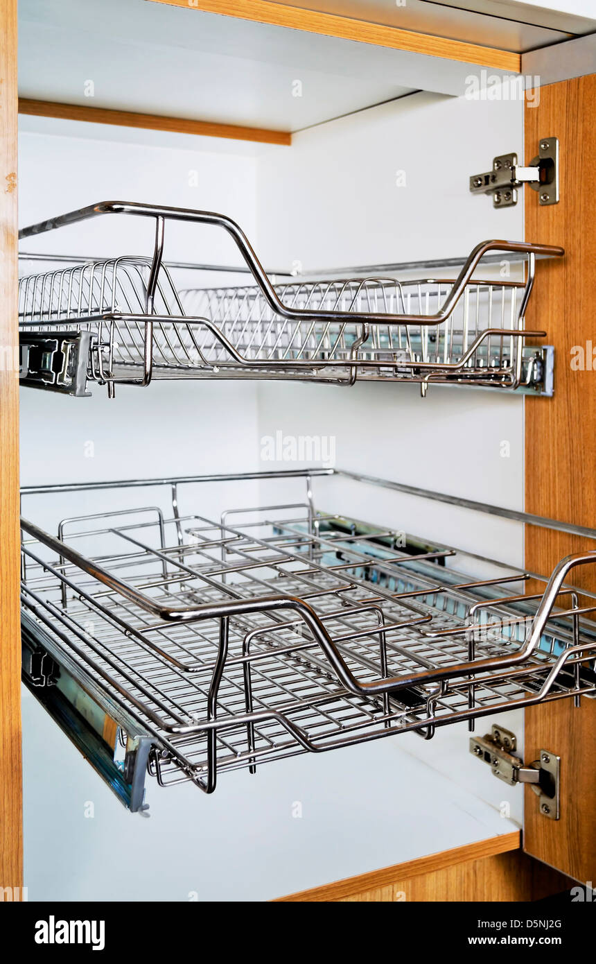 Open kitchen cabinet with two layers of stainless dish rack Stock Photo -  Alamy