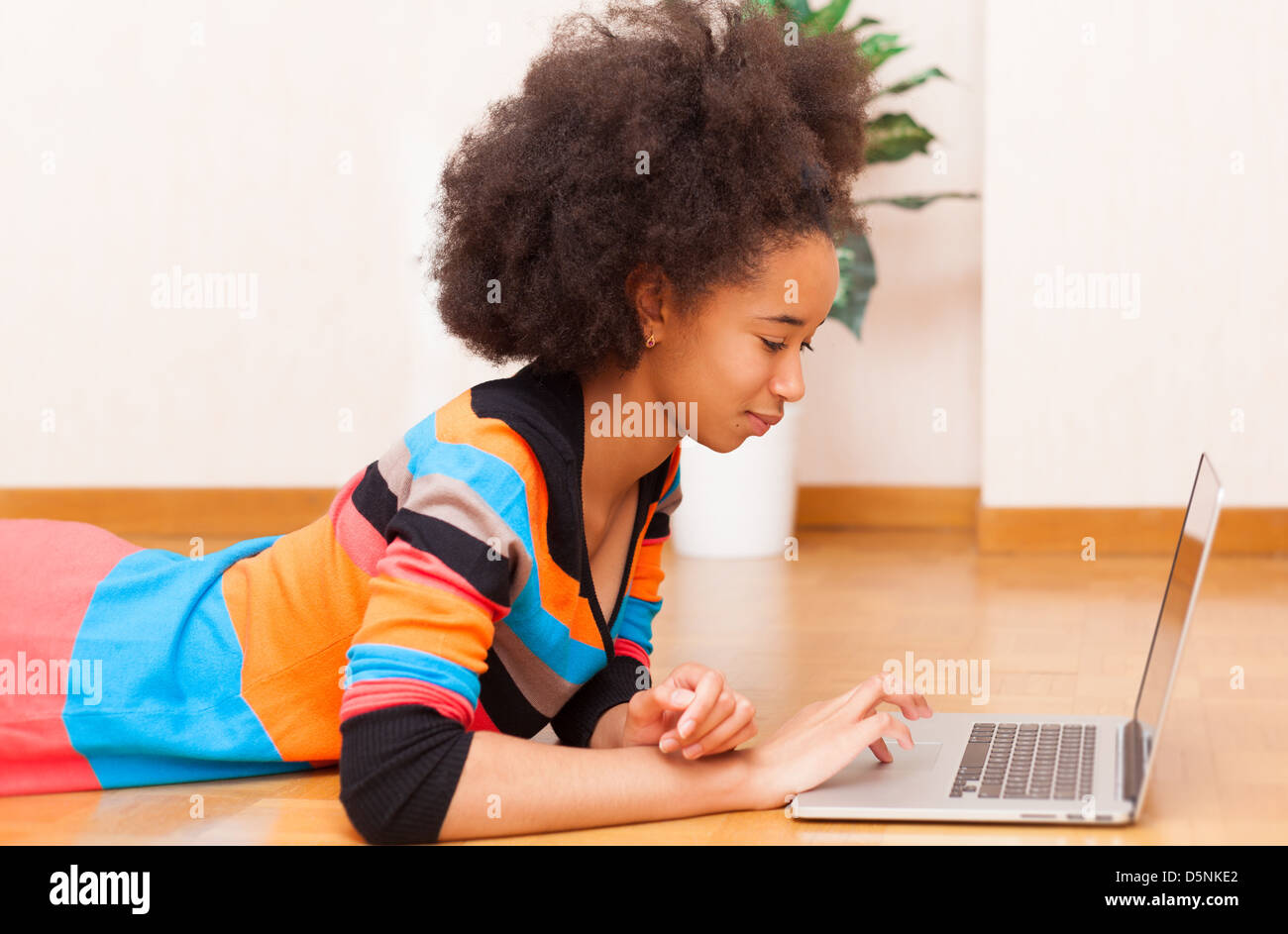 Black African American Teenage Girl With A Afro Haircut Seated On