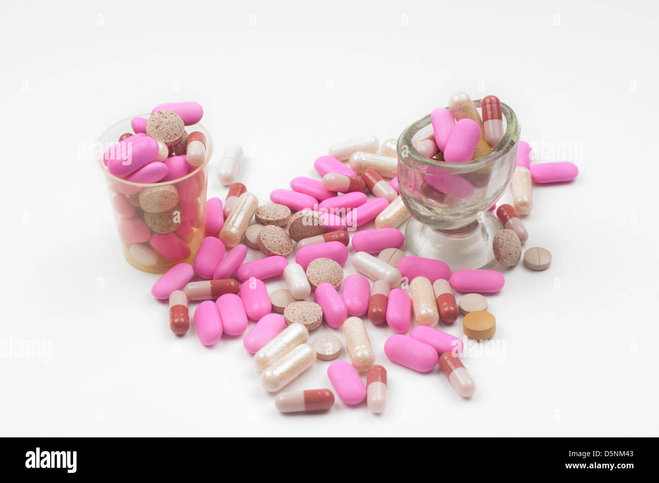 Lot of pink drugs (tablets) on light background Stock Photo - Alamy