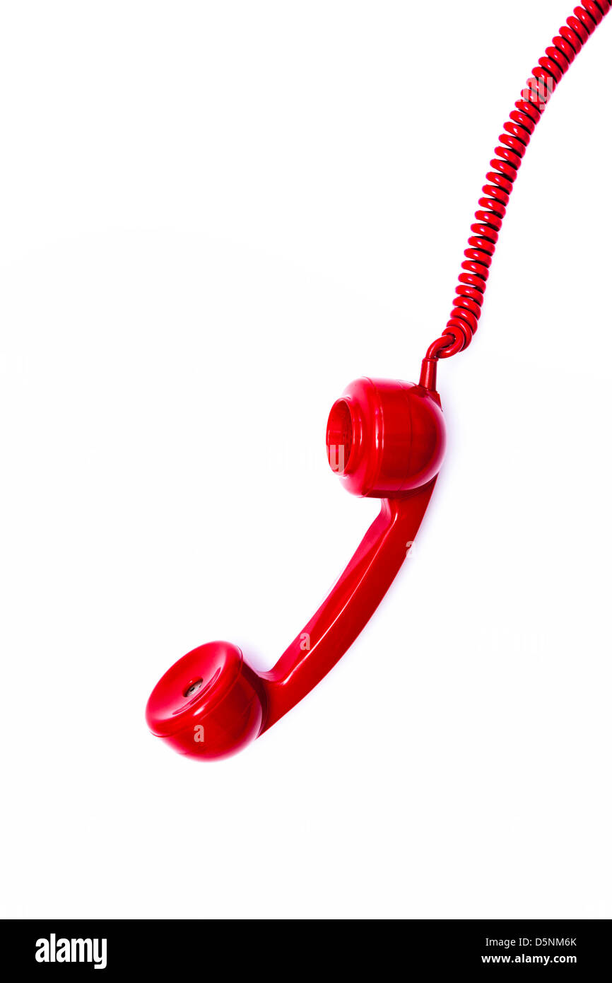 Red retro style telephone receiver and cord. Stock Photo