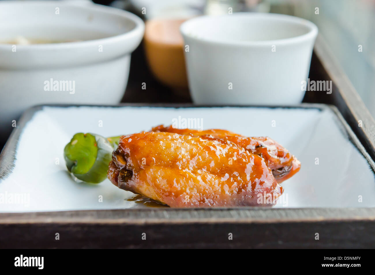 Fried Chicken Wings with sweet sauce on dish Stock Photo