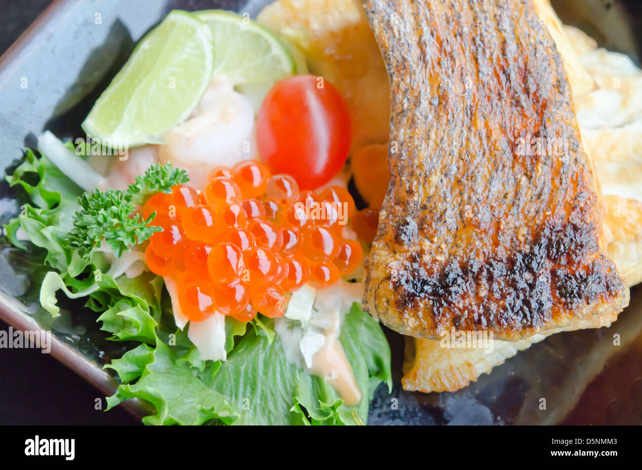 top view of fish egg with salad and grilled cod fish Stock Photo