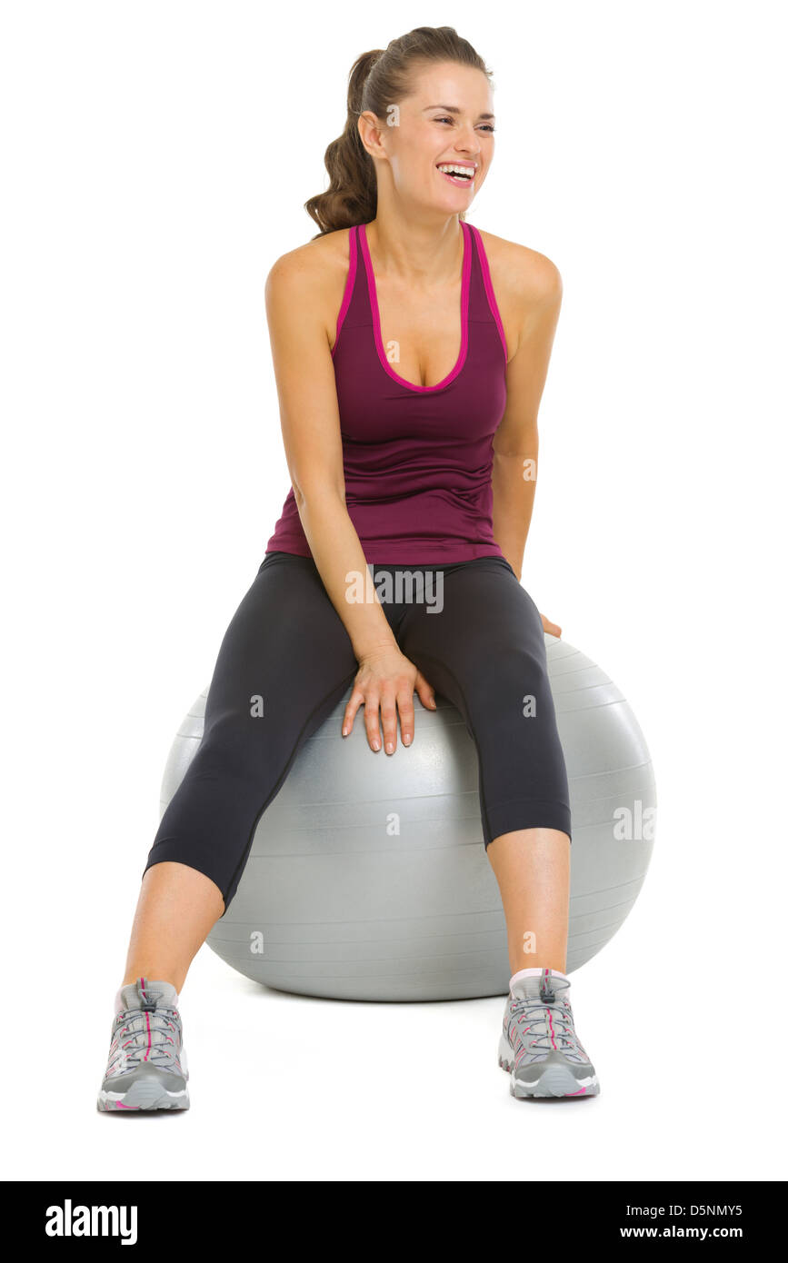 Smiling fitness young woman sitting on fitness ball Stock Photo - Alamy