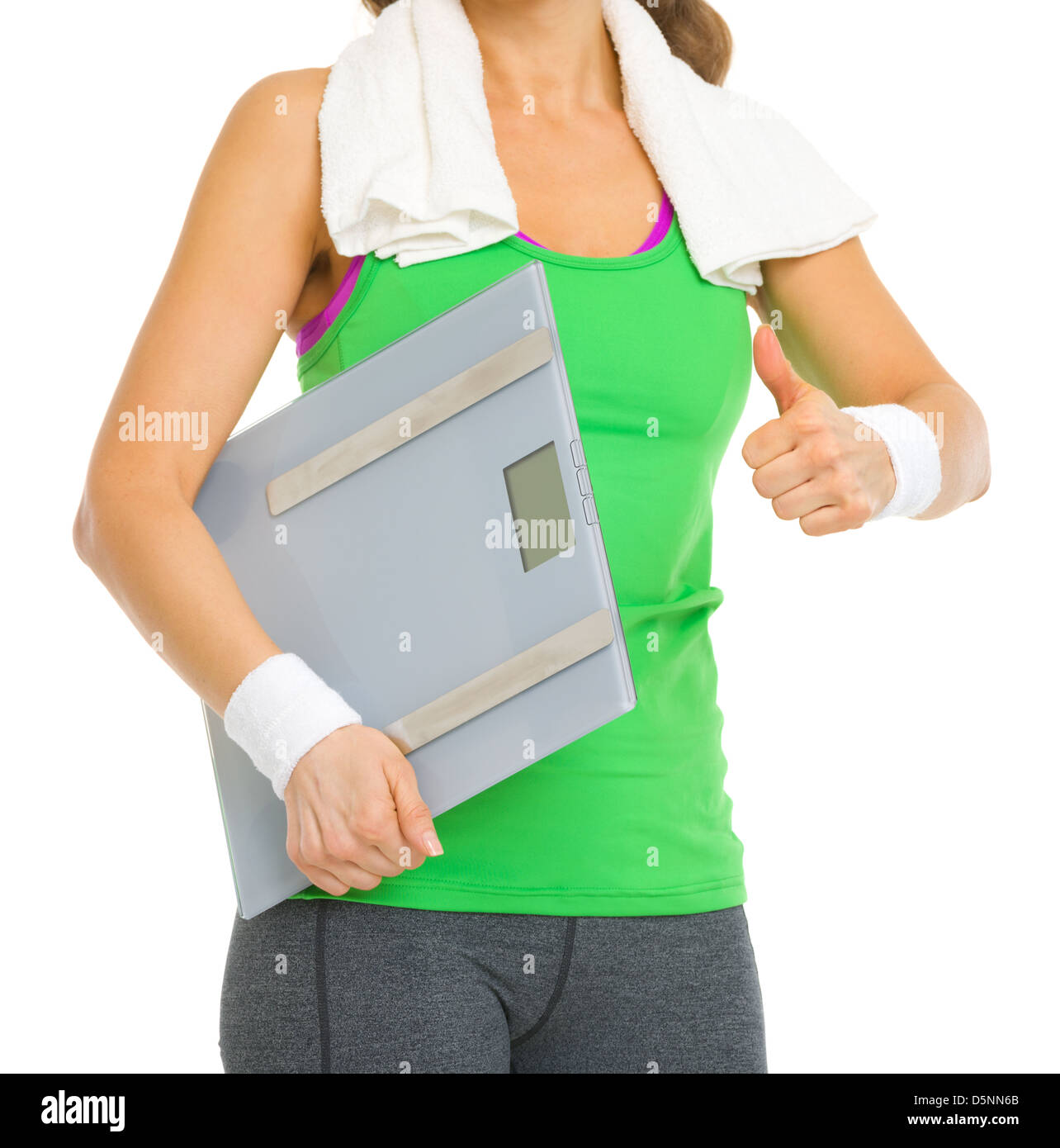 Closeup on fitness woman with scales showing thumbs up Stock Photo