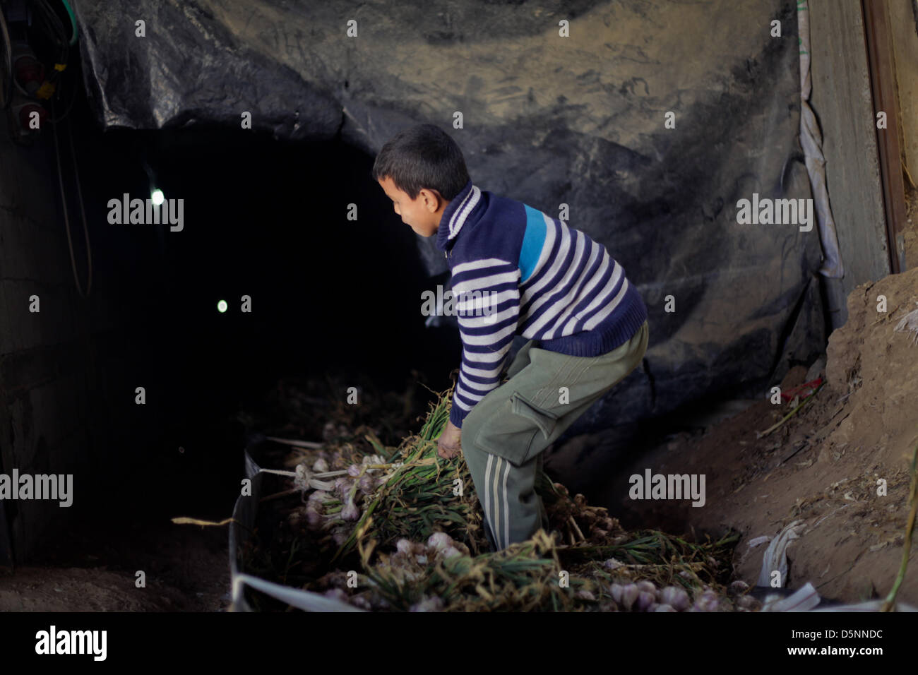A Palestinian Child in a tunnel beneath the Egyptian-Gaza border in Rafah, in the southern Gaza Strip Stock Photo