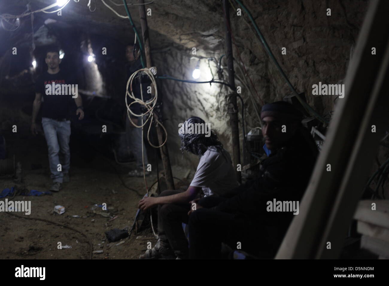A Palestinian workers moves through a smuggling tunnel from Egypt to Gaza under the border at Rafah. Stock Photo