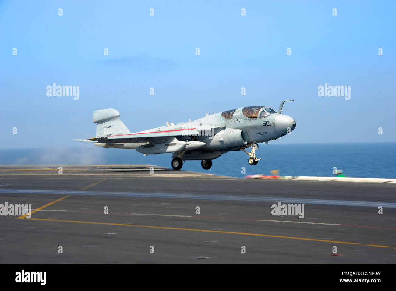 A US Navy EA-6B Prowler aircraft lands aboard the aircraft carrier USS Dwight D. Eisenhower April 3, 2013 in the Arabian Sea. Stock Photo