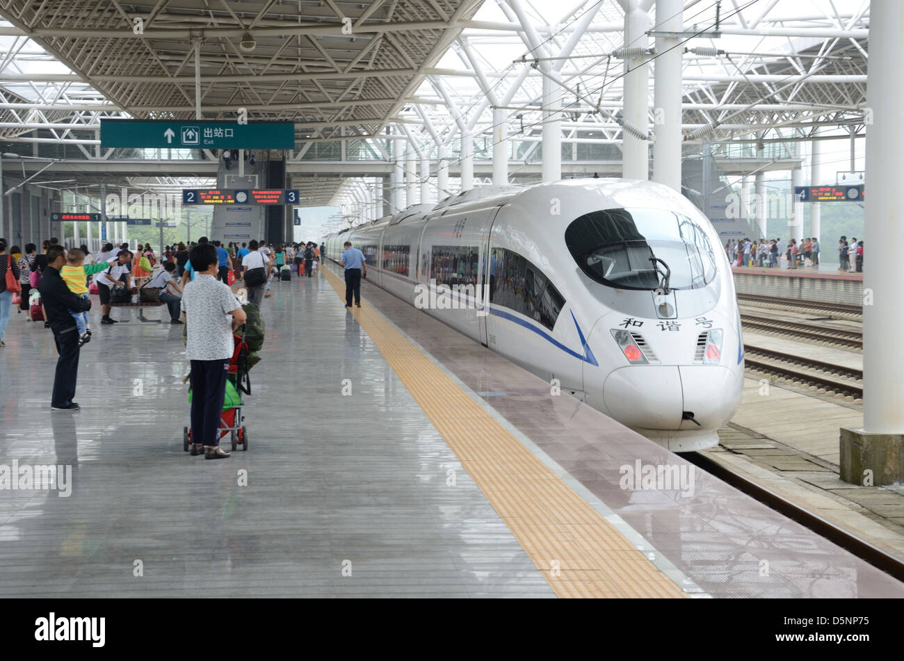 Passangers wait in YueYang railway station, fast train stops at the