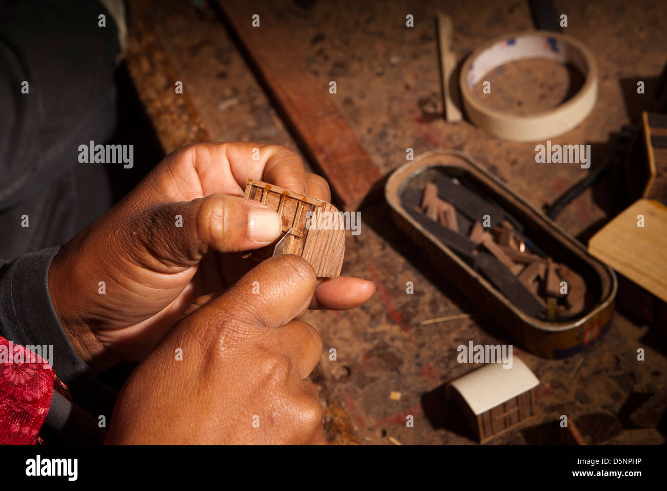 Madagascar, Antananarivo, Crafts, Le Village model boat making workshop, craftsman’s hands Stock Photo