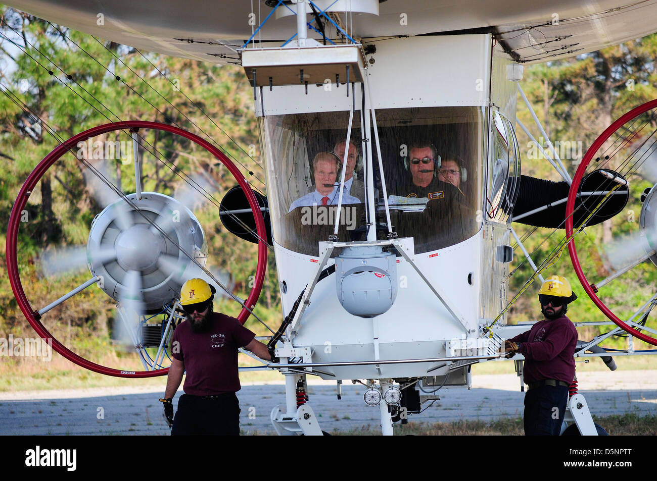 US Senator Bill Nelson, left, takes a familiarization flight aboard the Navy’s only manned airship the MZ-3A moored at Fernandina Beach Municipal Airport April 3, 2013 in Fernandina, Florida. The airship is a test platform for surveillance cameras, radars and other sensors. Stock Photo