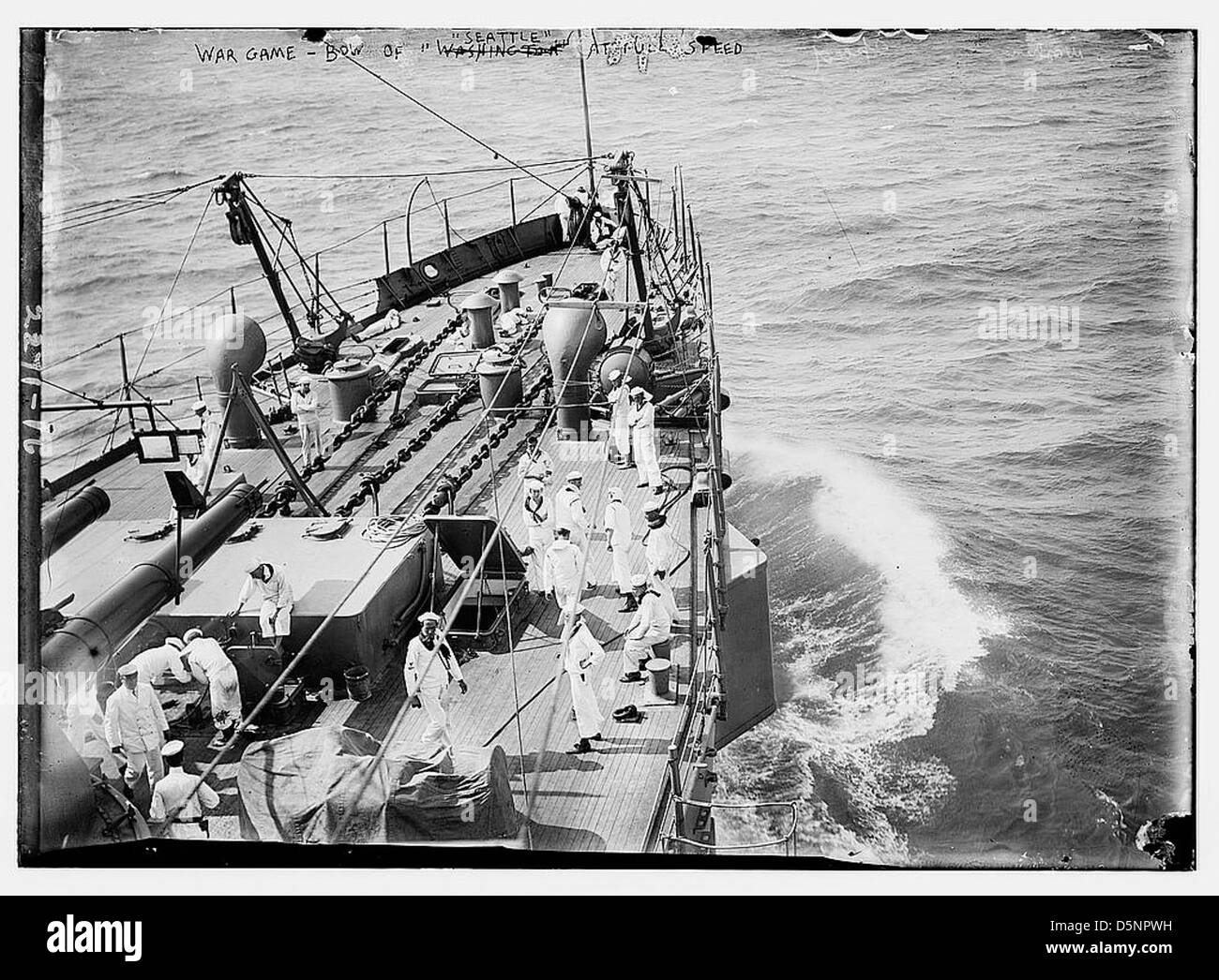 The USS Seattle (CA-11) engages in war games during the 1910s, showcasing its power as an armored cruiser. This image captures the ship at full speed during naval training exercises. Stock Photo