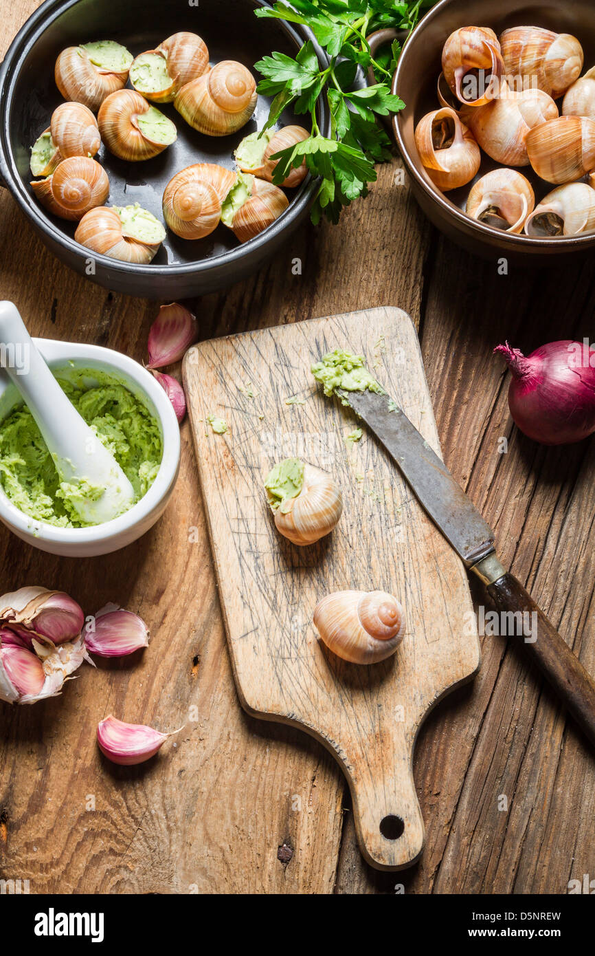 Preparing snails with garlic butter and herbs Stock Photo Alamy