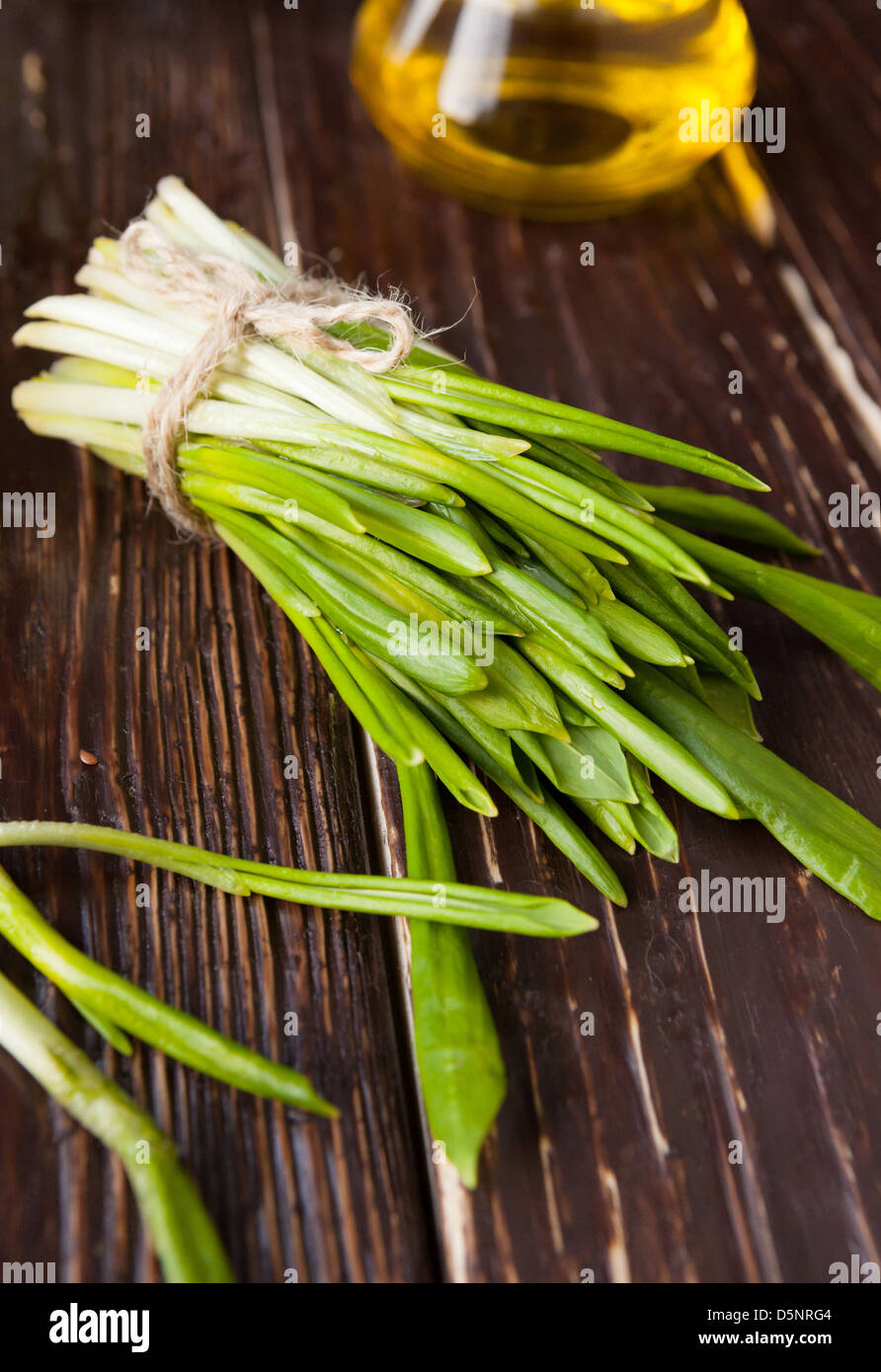 armful of ramson tied a rope on the boards, greens Stock Photo