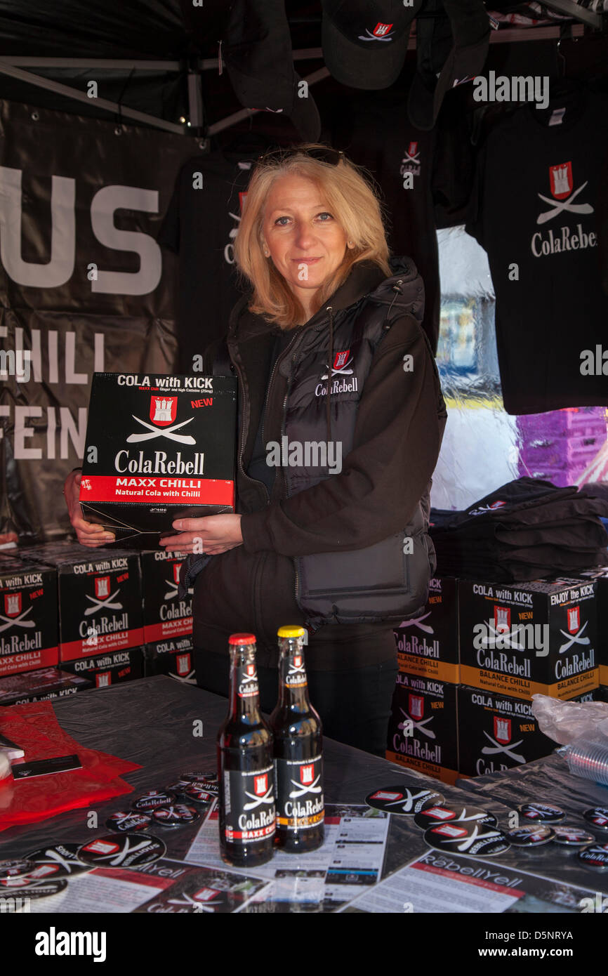 Blackpool, Lancashire,UK Saturday April 6th 2013. Maria Asker 50, s from Burton-on-Trent, selling Cola Rebell at the Great Blackpool Chilli Festival in the beautiful revamped St Johns Square, an landmark  event organised by Chilli Fest UK. The venue owners Blackpool Bid are keen to make Blackpool Chilli Festival one of its main attractions during the peak holiday season. Stock Photo