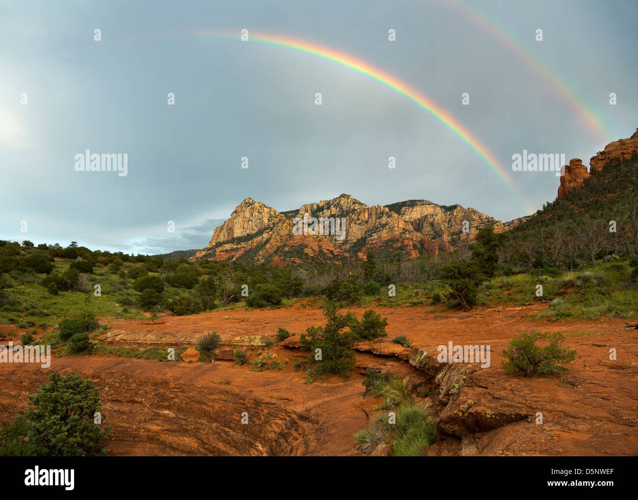 Double rainbow arching over mountains of Sedona at sunset Stock Photo